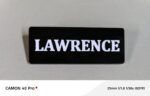 Custom engraved black name badge with white text LAWRENCE
